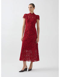 Woman wearing a red lace dress on a white background