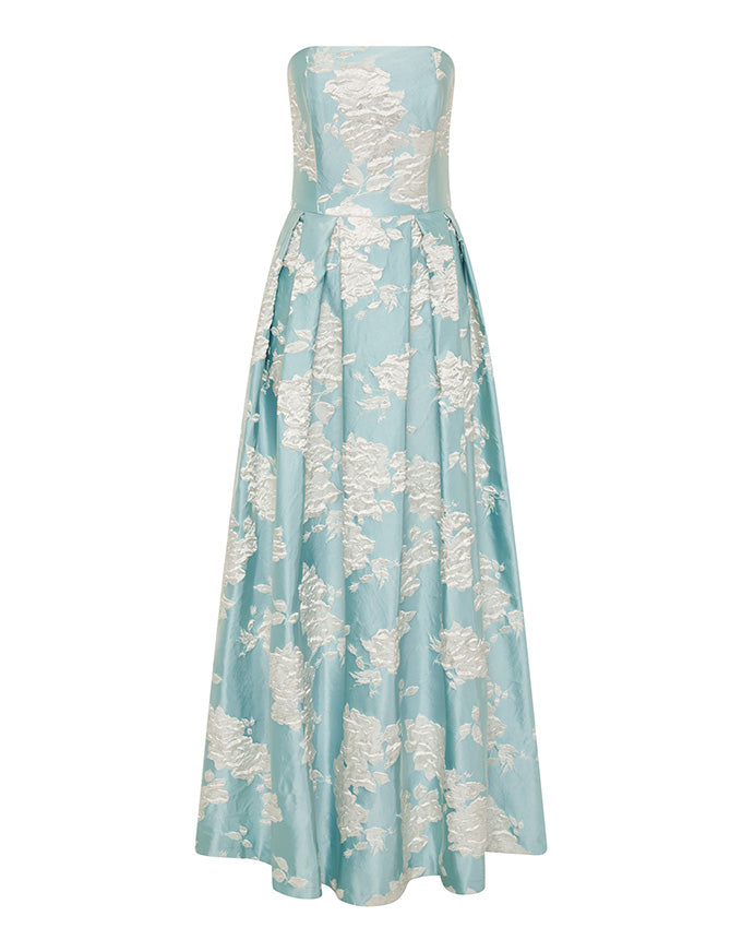 A strapless floor-length gown in light aqua blue with an allover raised floral brocade pattern in a warm ivory or cream tone, shown against a plain white background.
