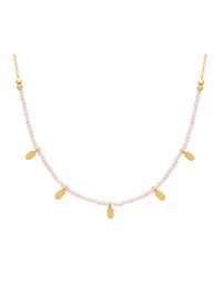 Necklace with pink beads and gold accents on a white background