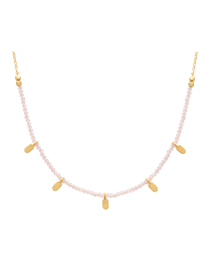 Necklace with pink beads and gold accents on a white background