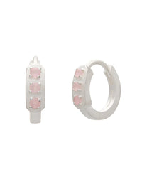 Pair of hoop earrings with pink gemstones on a white background
