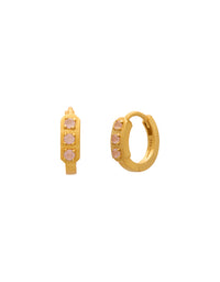 Gold hoop earrings with pink stones on a white background