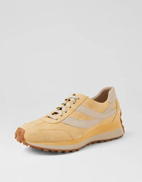 Yellow and beige sneaker on a light gray background