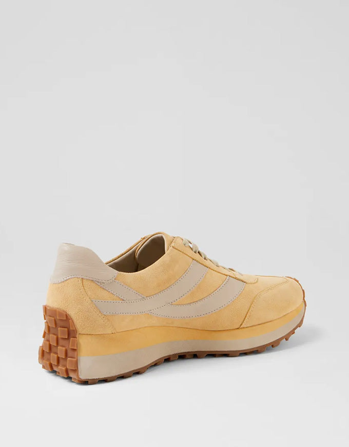 Yellow and beige sneaker on a light gray background