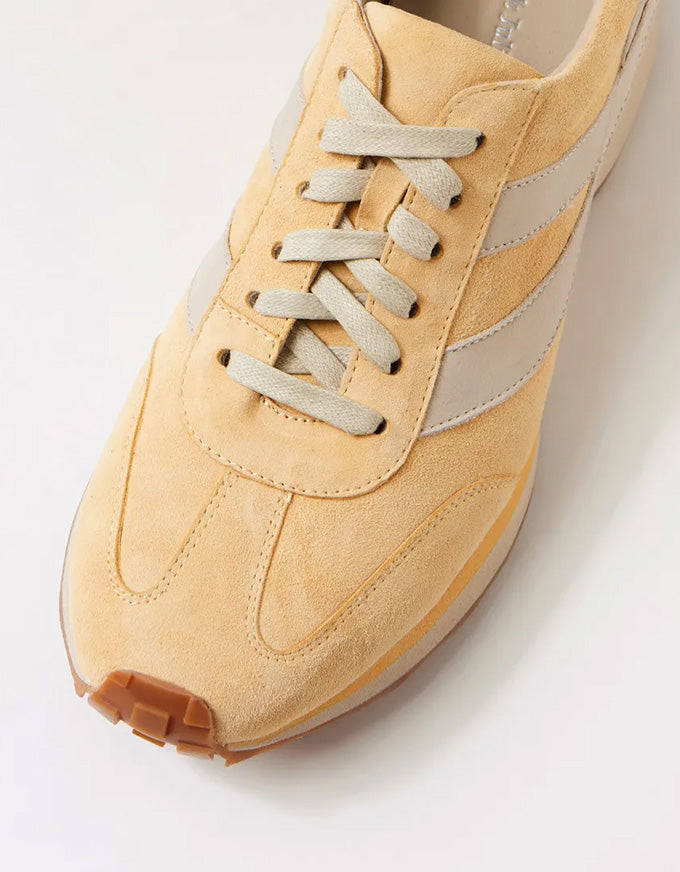 light yellow suede sneaker on a white background