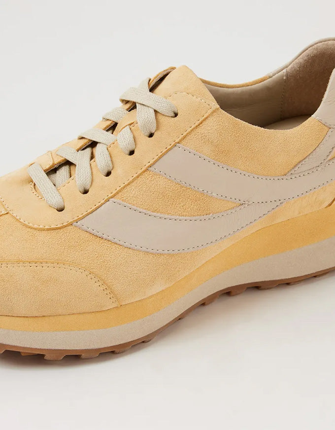 light yellow suede sneaker with neutral accents on a white background