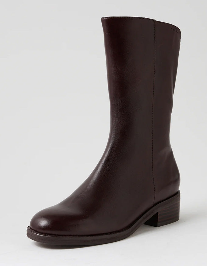 Brown leather boot on a light gray background