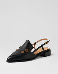 Black leather slingback shoe with gold buttons on a light gray background