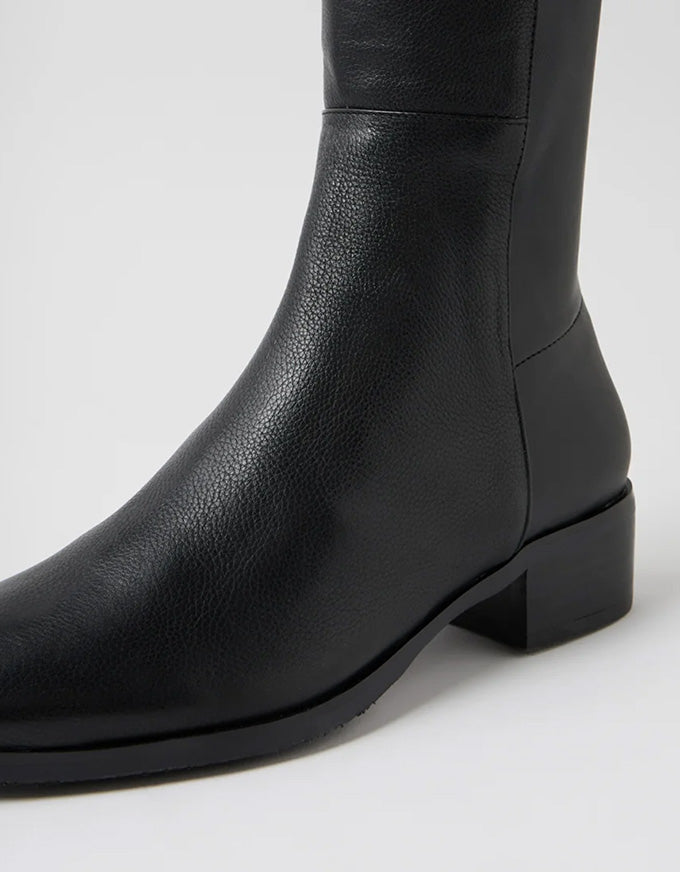 Black leather knee-high boot on a white background