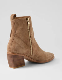 Brown suede ankle boot with a gold zipper on a light gray background