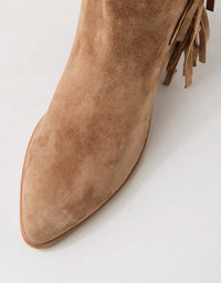 Brown suede ankle boot with fringe details on a light gray background