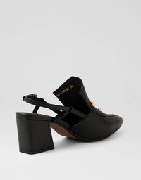 Black high-heeled shoes on a light gray background