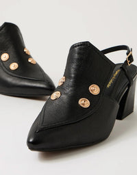 Black high-heeled shoes with gold embellishments on a light gray background