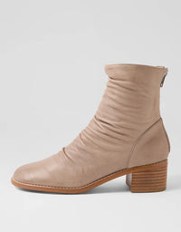Beige ankle boot on a light gray background