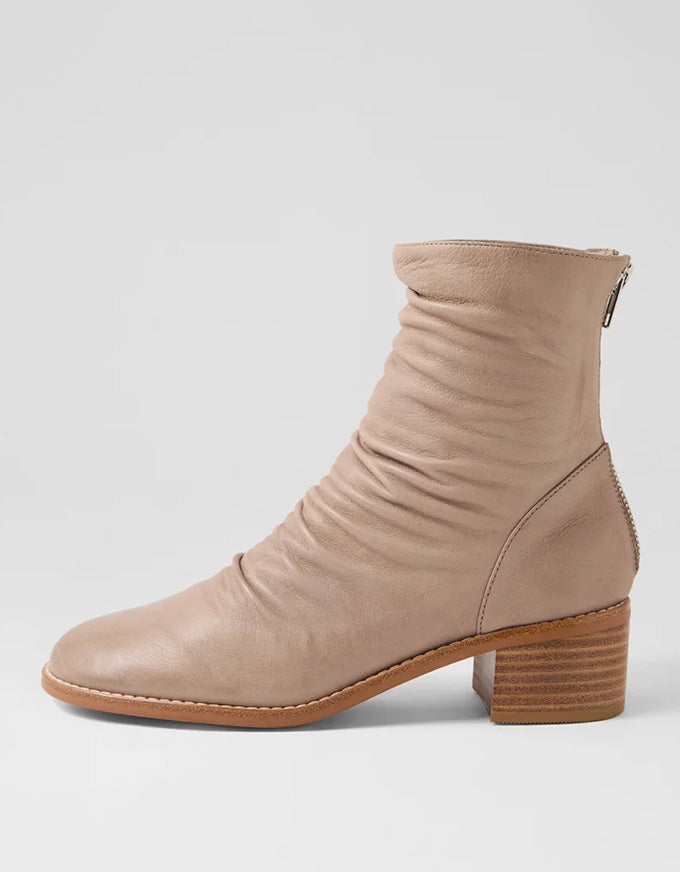 Beige ankle boot on a light gray background