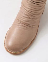Close-up of a beige boot on a white background