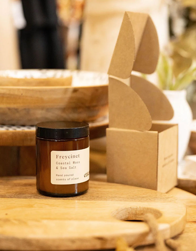 Jar of Freycinet coastal honey on a wooden surface with blurred background