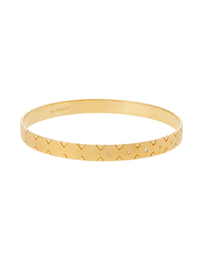 Gold bracelet with a textured pattern on a white background