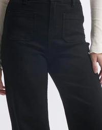 Black pants worn by a person on a white background
