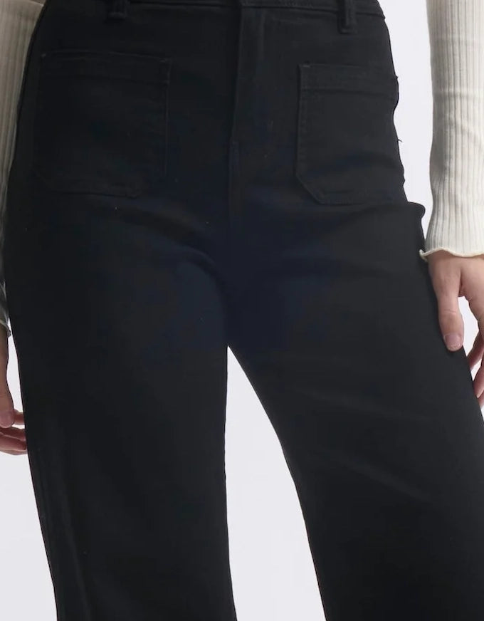 Black pants worn by a person on a white background