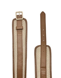 Brown leather strap with beige interior on a white background