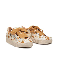Pair of animal print sneakers with mustard yellow laces on a white background