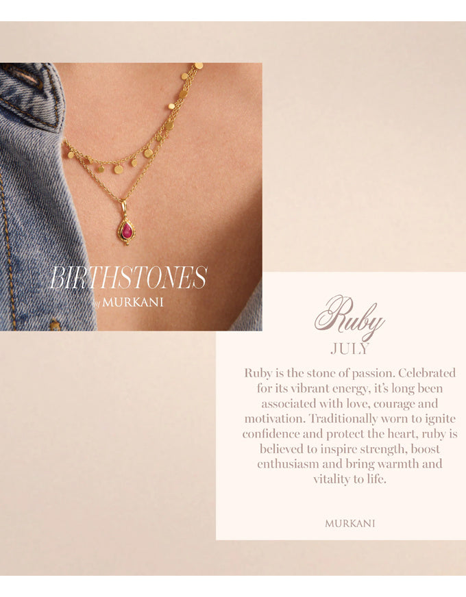 Necklace with a ruby pendant worn by a person, with text about birthstones and rubies.