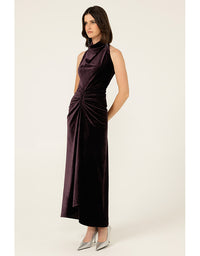 Woman wearing a sleeveless purple dress with a draped neckline on a white background