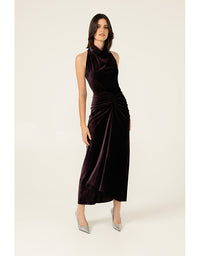 Woman wearing a dark purple dress on a white background