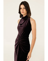 Woman wearing a dark purple dress on a white background