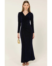 Woman wearing a long navy dress with long sleeves on a white background