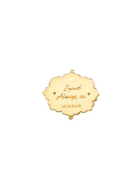 Gold pendant with engraved text on a white background