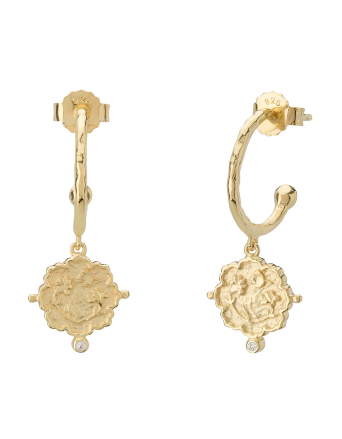 Gold hoop earrings with floral designs on a white background