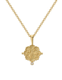 Gold necklace with a decorative pendant on a white background