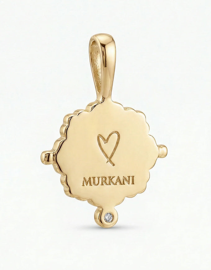 Gold pendant with 'MURKANI' and a heart design on a white background