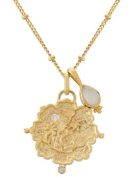 Gold necklace with intricate pendant and teardrop-shaped gem on a white background
