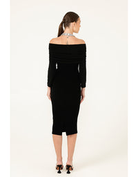 Woman wearing a black off-shoulder dress on a white background