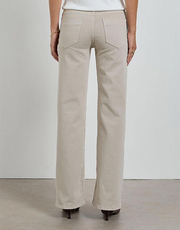 Beige pants worn by a person on a plain background