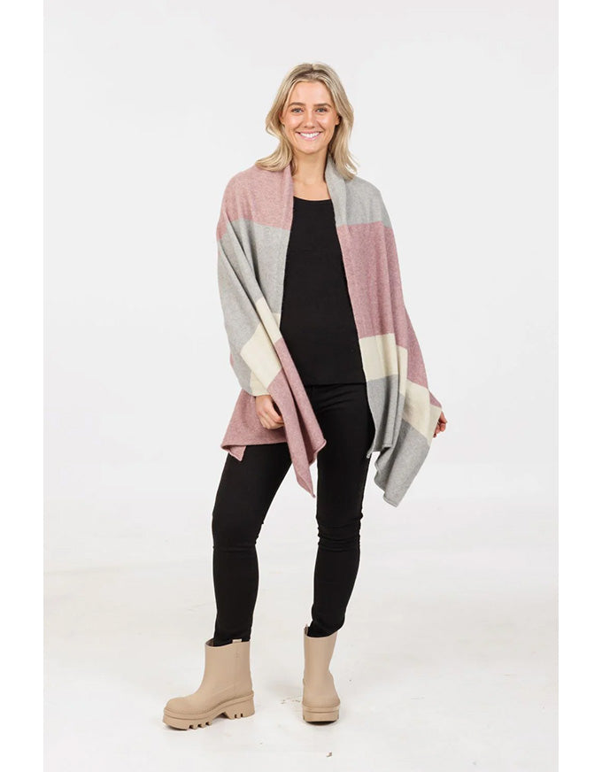 Woman wearing a stripe scarf over a black outfit on a white background