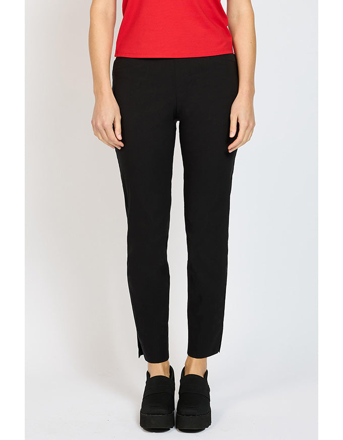 Person wearing black pants and a red top on a white background