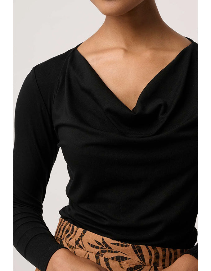 Black long-sleeve top worn by a person on a plain background