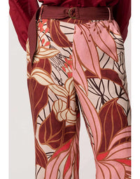 Floral patterned pants with a belt on a white background