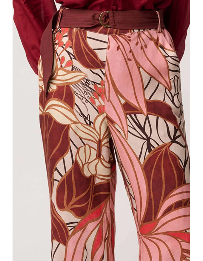 Floral patterned pants with a belt on a white background