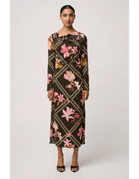 Woman wearing a floral patterned dress on a white background
