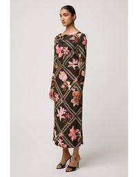 Woman wearing a floral dress with a geometric pattern on a white background