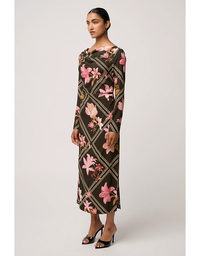 Woman wearing a floral dress with a geometric pattern on a white background
