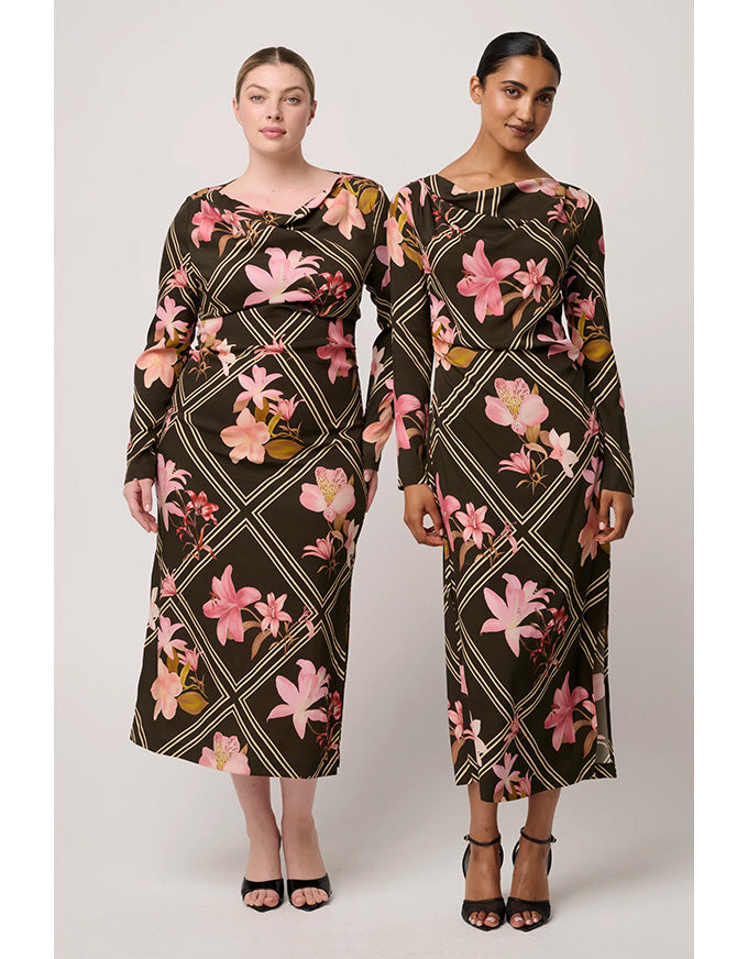 Two models wearing floral patterned dresses on a white background