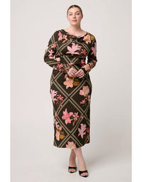 Woman wearing a floral dress with a geometric pattern on a white background