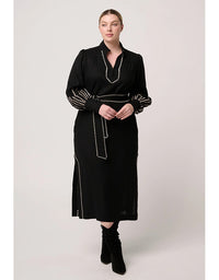Woman wearing a black dress with decorative elements on a white background