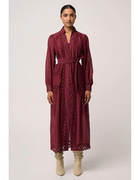 Woman wearing a burgundy lace dress on a white background